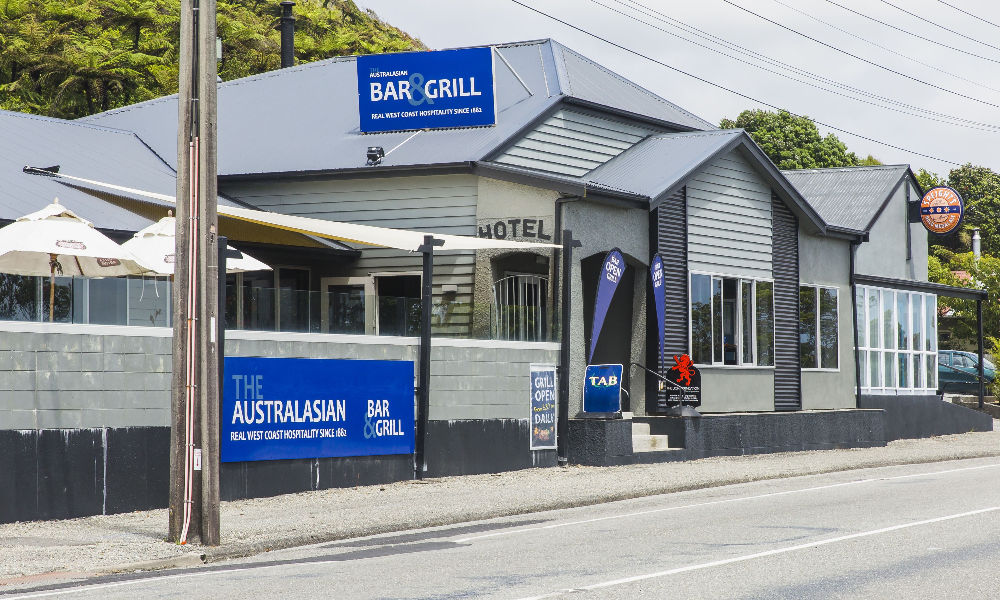 A building with a sign for 'The Australasian Bar & Grill' and a 'Hotel' sign above the entrance.