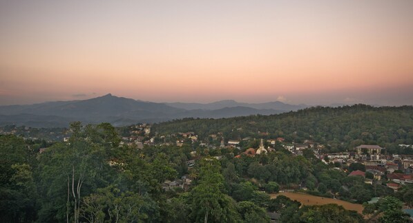 A town nestled in a valley with a prominent mountain in the background.
