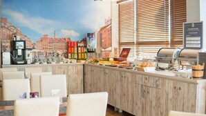 A buffet area with a variety of food options, a coffee machine, and a cityscape mural on the wall. - Gordon Hotel (Warsaw)