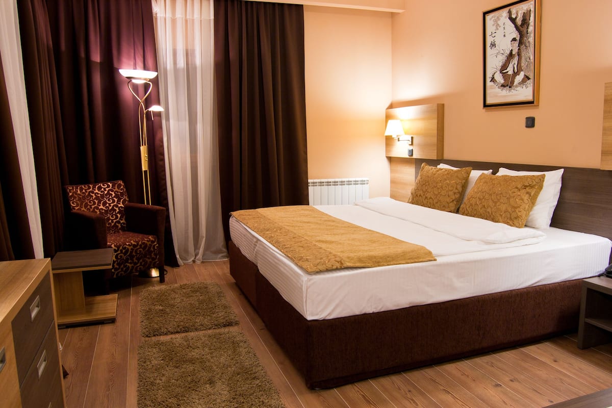 classic twin room, 1 bedroom, smoking, park view | minibar, in-room safe, desk, iron/ironing board