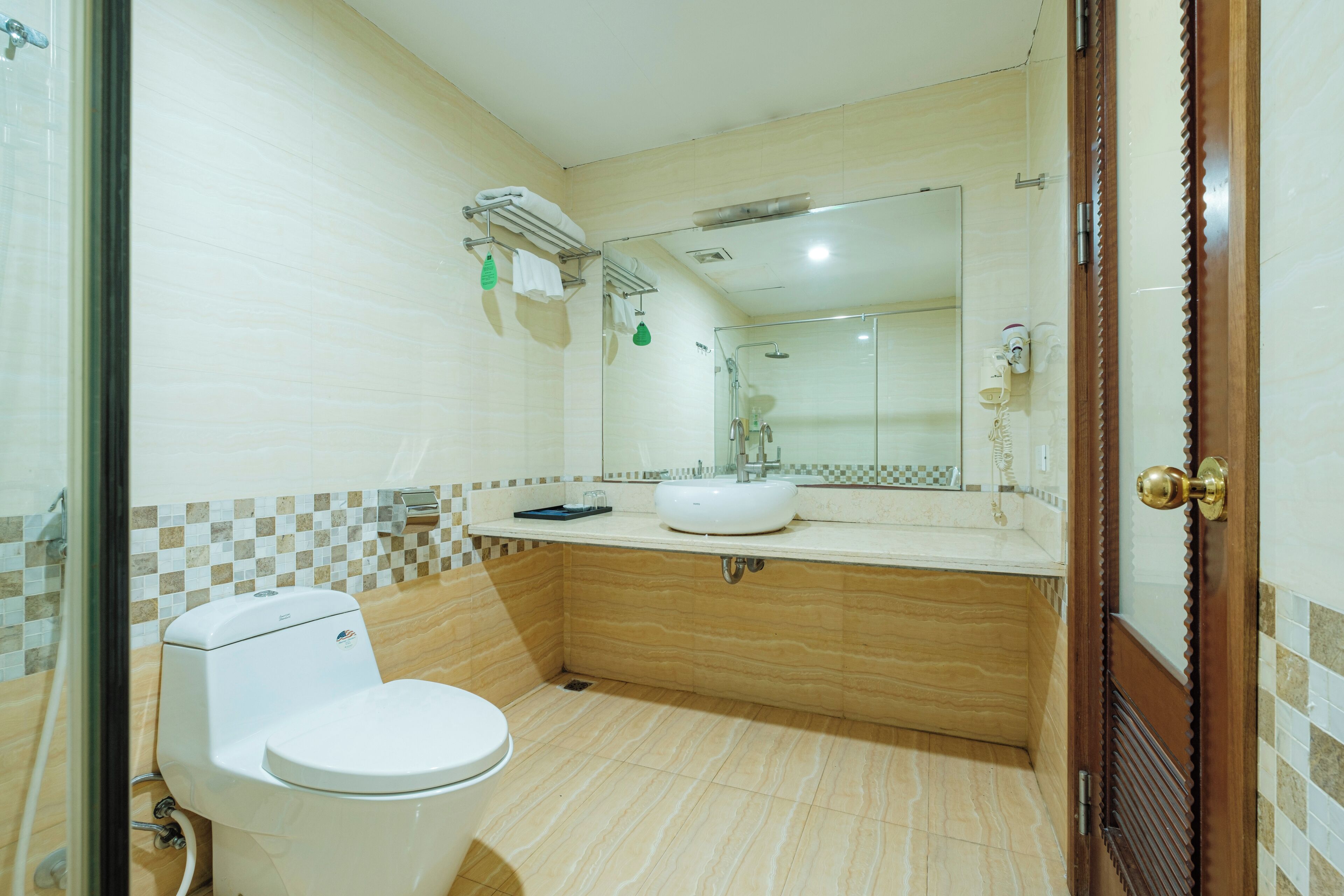 A bathroom with a toilet, sink, and shower.
