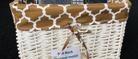 A wicker basket with a label indicating it is for guest information at a thermal motel.
