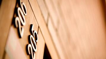 A close-up of wooden numbers '205' on a wall.