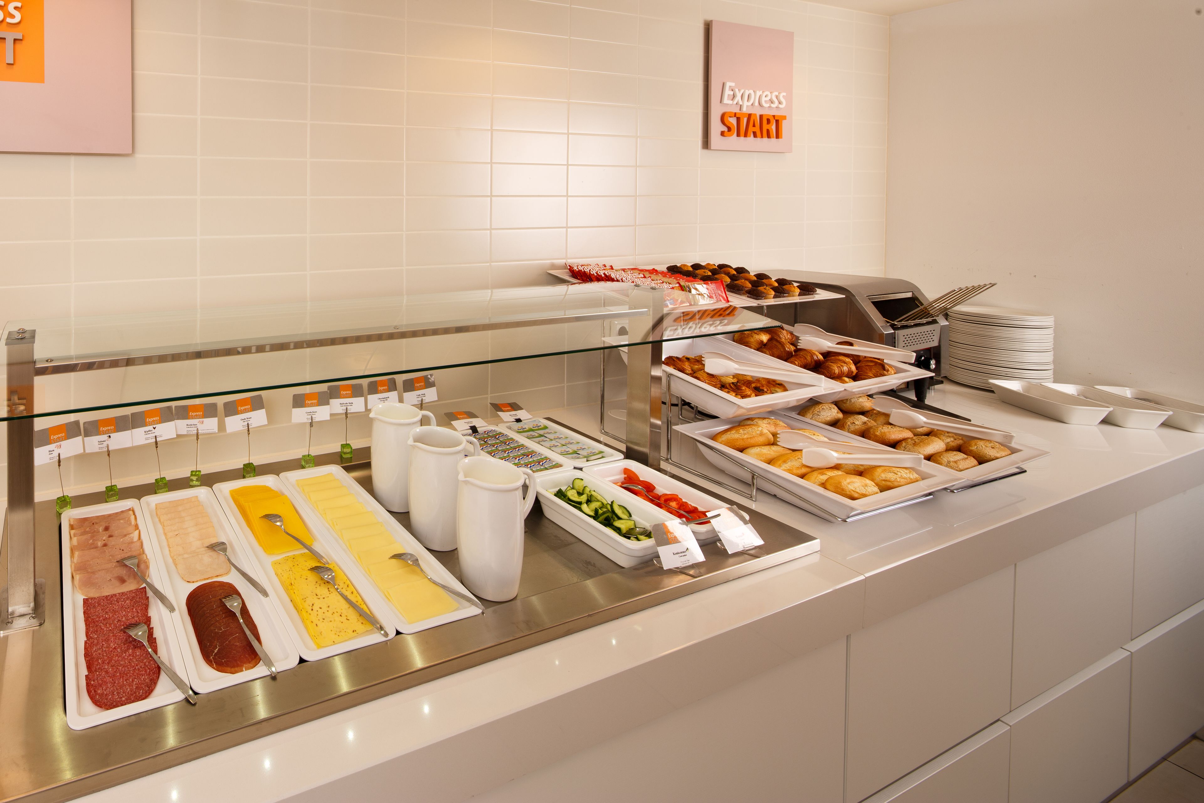 A buffet with various food items and condiments.