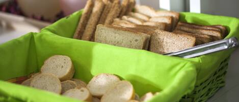 A basket of sliced bread in a green basket.