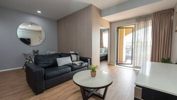 Apartment, 1 Bedroom | Living area | 50-inch LCD TV with cable channels, TV, DVD player