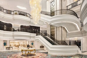 A grand hotel lobby with a central staircase, multiple levels, and a chandelier. - Shangri-La Bosphorus, Istanbul (Istanbul)