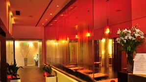 A reception area with a glass partition, a reception desk, and potted plants. - Sol Victoria Hotel, Spa & Casino (Victoria)
