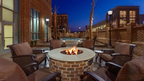 A brick building with a pool, outdoor seating, and a fire pit. - Embassy Suites by Hilton Savannah Historic District (Savannah)