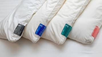 A bed with pillows and a blanket.