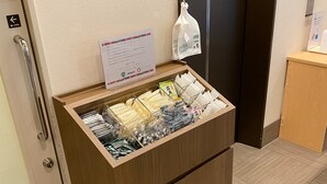 A wooden cabinet with a glass front displaying various items. - Dormy Inn Express Matsue (Matsue)