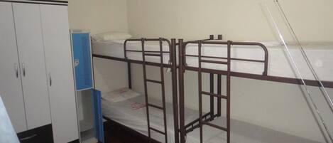 A bunk bed room with a wardrobe and a desk.