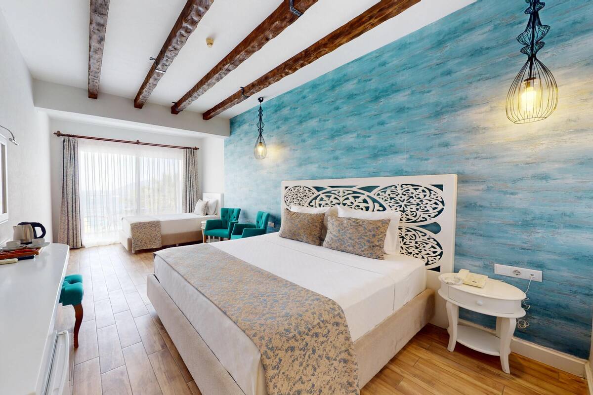 Standard Triple Room, Sea View | Pillowtop beds, minibar, in-room safe, desk