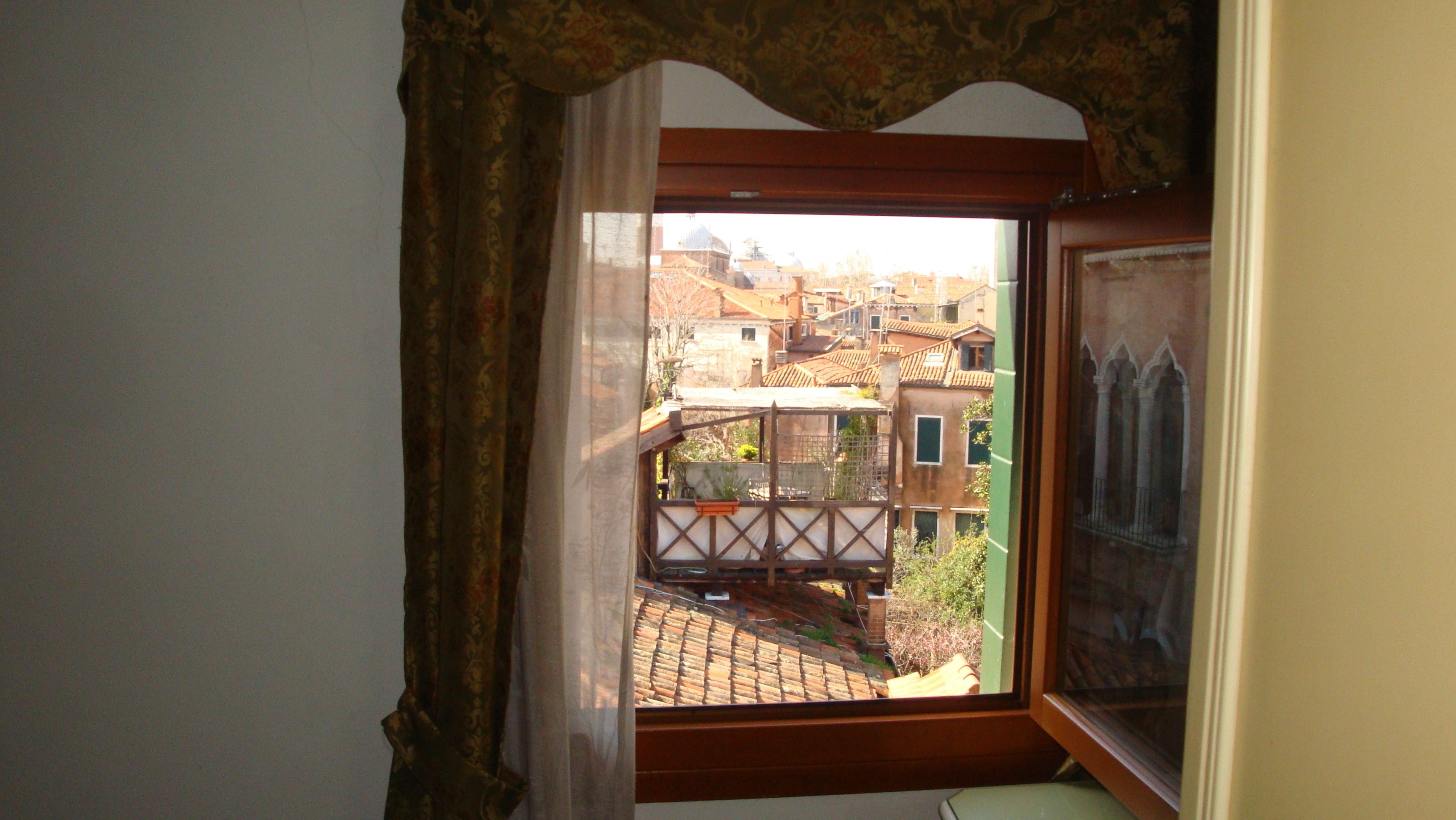 A room with a window overlooking a cityscape.