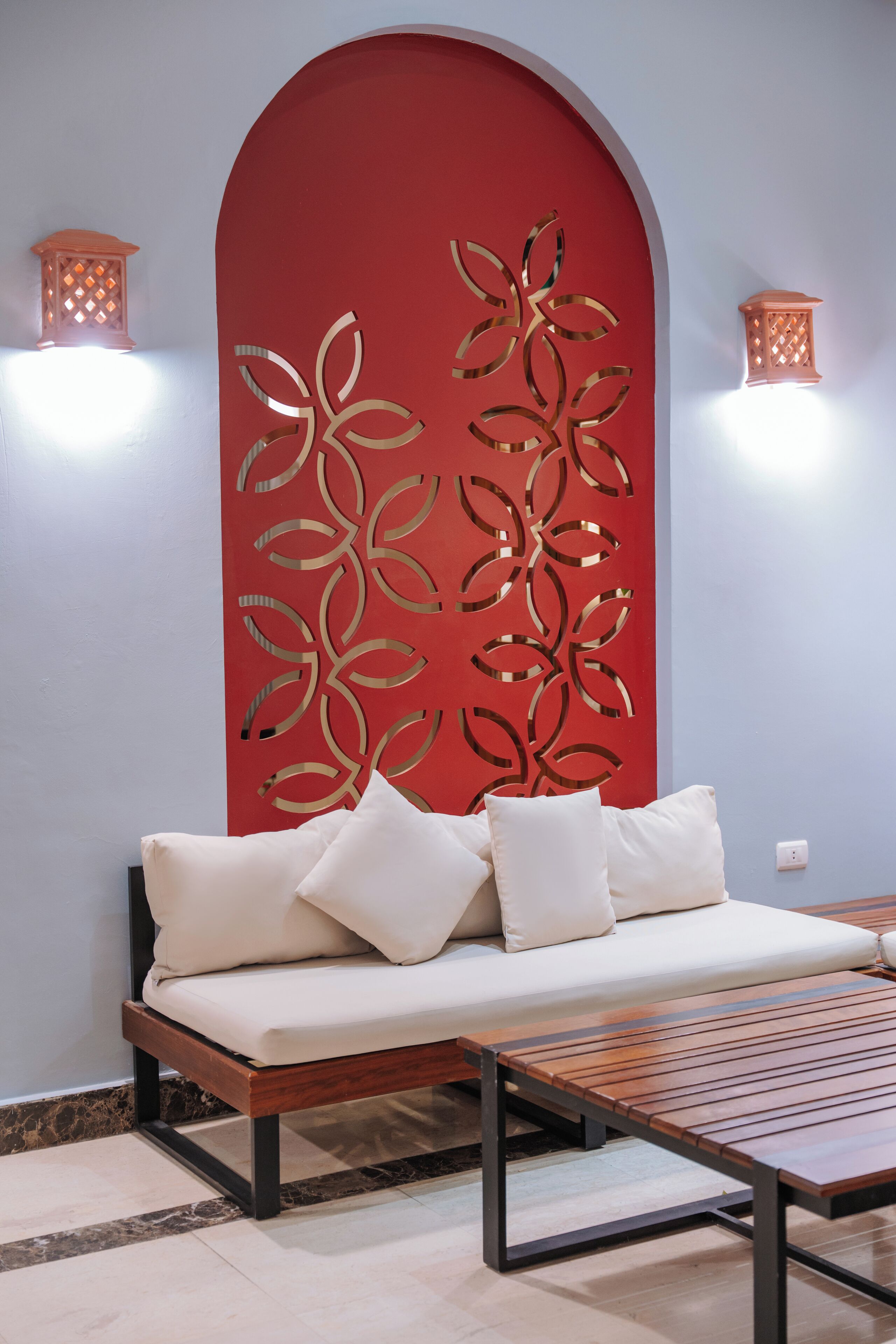 A modern room with a sofa, a wooden table, and decorative wall panels.