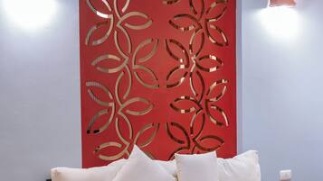 A modern room with a sofa, a wooden table, and decorative wall panels.
