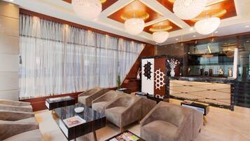 A modern living room with a sofa set, a coffee table, and a decorative cabinet.