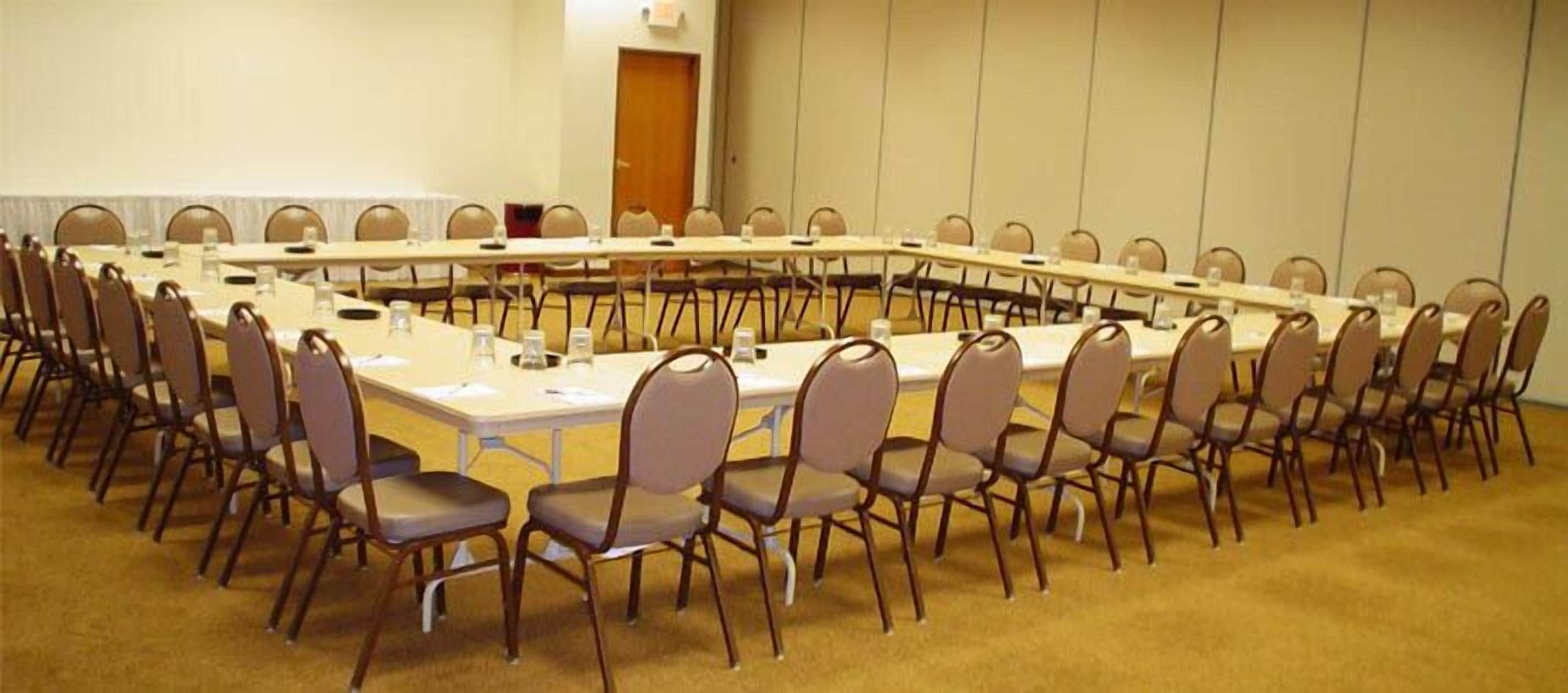 A conference room with a long table and chairs arranged for a meeting.