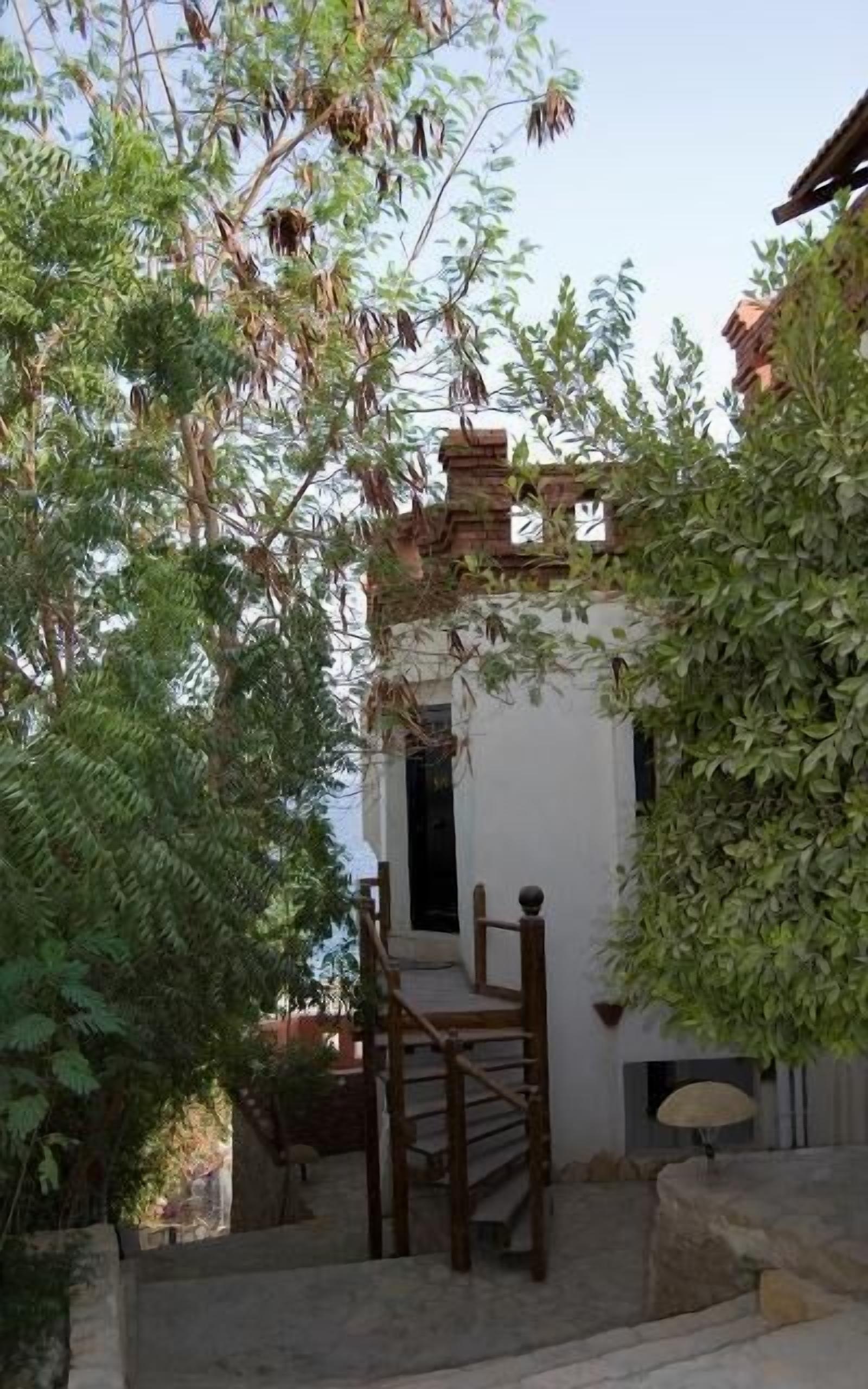 A traditional building with a stone staircase leading to a wooden door.