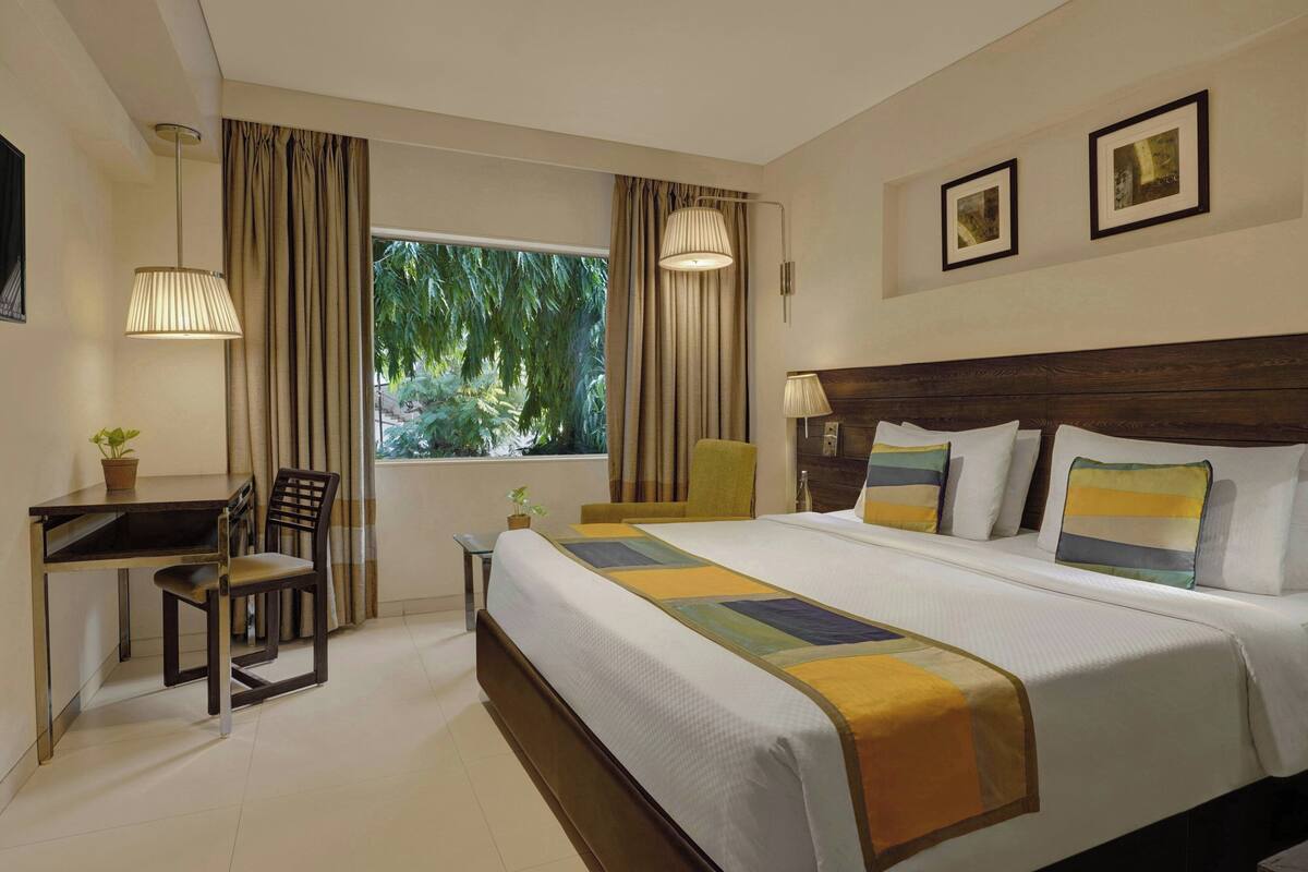 Room, 1 King Bed, City View | Minibar (some free items), in-room safe, desk, blackout drapes