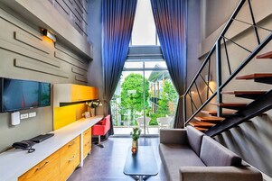 Duplex | Living room | 32-inch LCD TV with cable channels, TV, DVD player