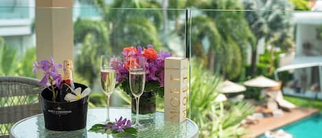 A table with a bottle of Moët & Chandon champagne, two champagne flutes, and a book titled 'MOET MOET'.