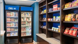 A vending area with two refrigerators labeled "CHILL OUT" and a shelf stocked with snacks and beverages. - Hampton Inn & Suites Pensacola/Gulf Breeze (Gulf Breeze)
