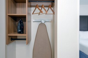 Desk, laptop workspace, blackout drapes, iron/ironing board