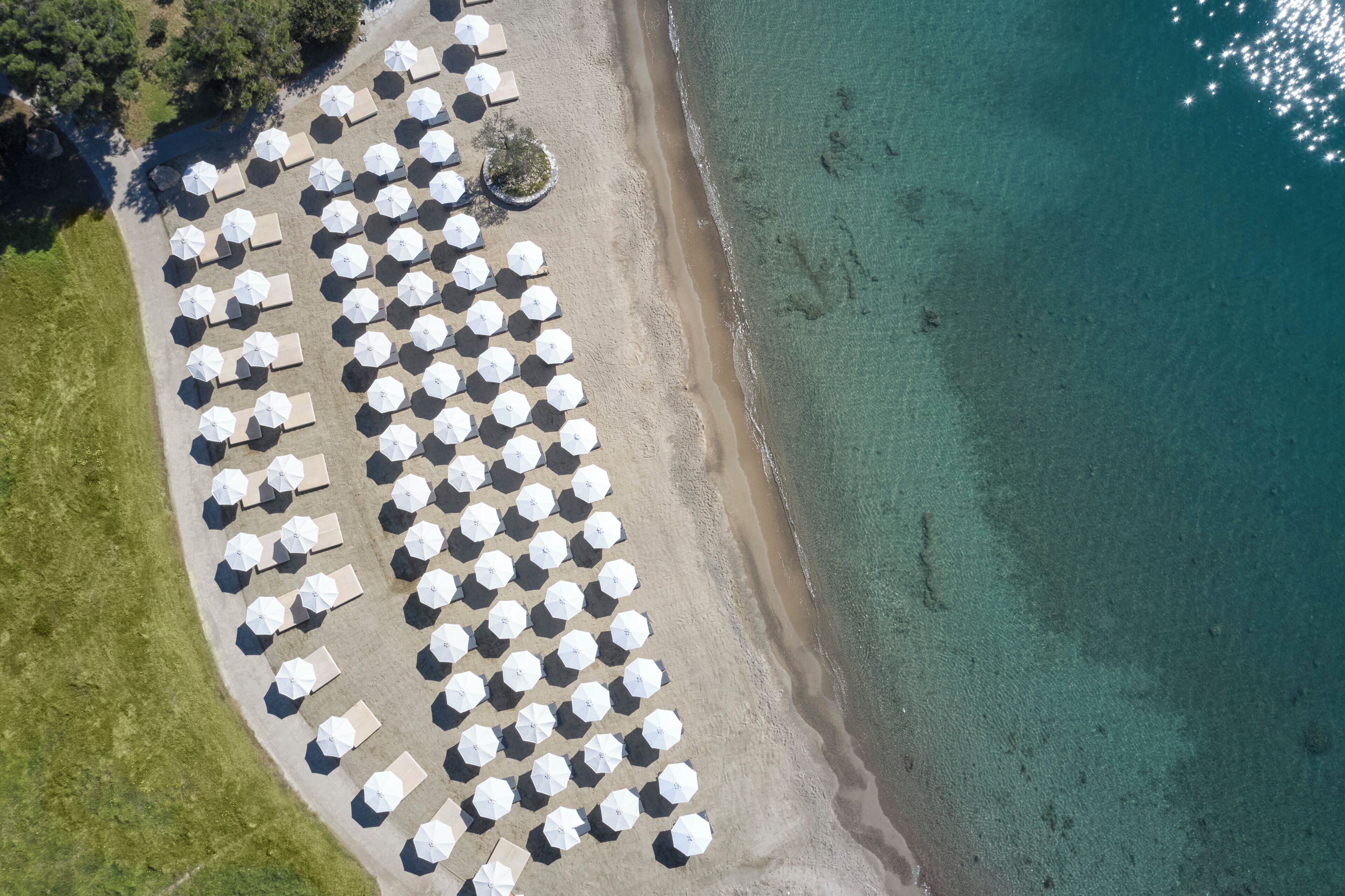 On the beach, white sand, sun loungers, beach umbrellas