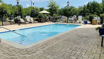 Una piscina al aire libre, sombrillas