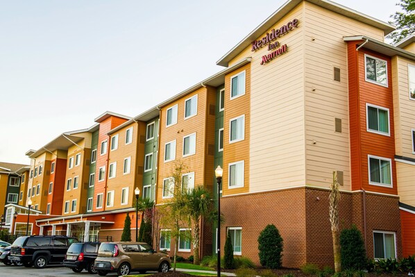 A multi-story hotel with a brick facade and multiple windows.