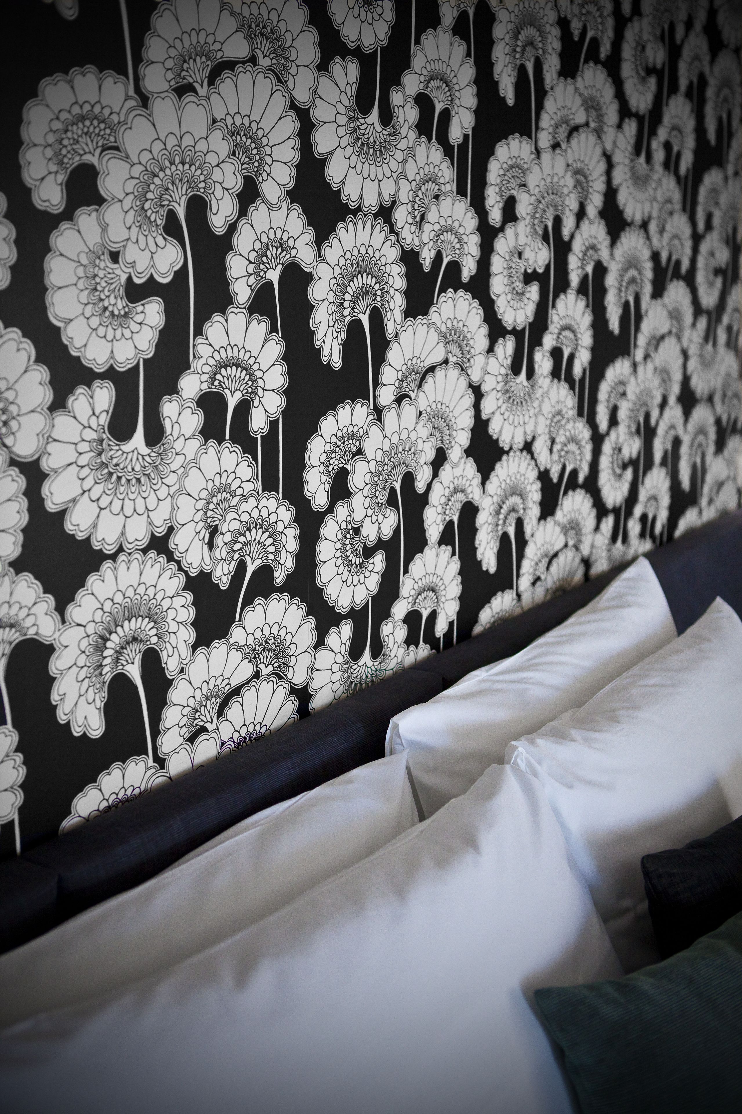A wall with a black and white floral pattern.