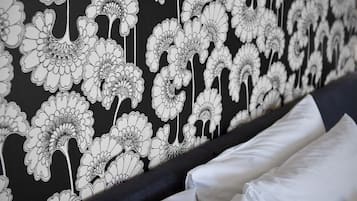 A wall with a black and white floral pattern.