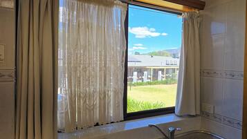 Comfort Room | Desk, laptop workspace, blackout drapes, iron/ironing board