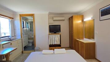 Comfort Room | Desk, laptop workspace, blackout drapes, iron/ironing board