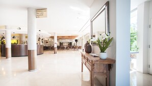 A spacious lobby with a reception desk, seating area, and a sign indicating amenities like a restaurant, conference room, bar, gaming, and an ATM. - Ramada Hotel & Suites Sydney Cabramatta (Cabramatta)