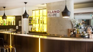 A bar area with a sign reading "MILANO GRILL & BAR," featuring a counter with bottles and a display of various liquors. - Ramada Hotel & Suites Sydney Cabramatta (Cabramatta)