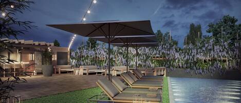 A modern outdoor lounge area with a pool, lounge chairs, and a pergola with hanging lights.