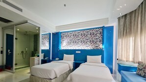 A hotel room with two beds, a shower, and a large window with patterned curtains. - Arenaa Star (Kuala Lumpur)