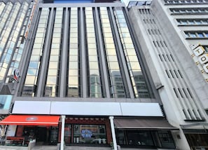 A modern building with a reflective glass facade, a prominent red awning, and a visible sign for 'Redoor Coffee.' - Arenaa Star (Kuala Lumpur)