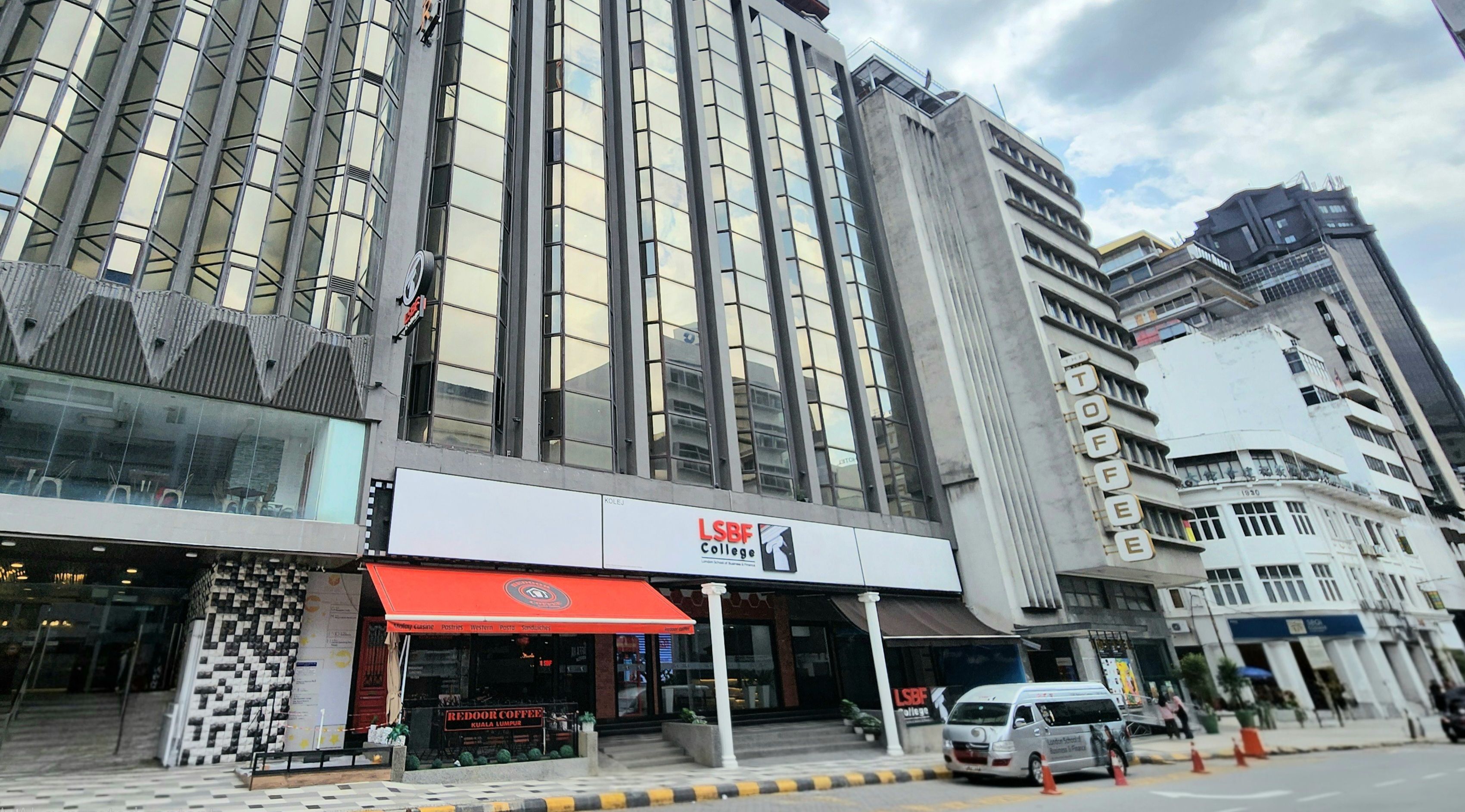 A modern building with a prominent 'LSBF College' sign, a red awning, and a 'Redoor Coffee' shop.