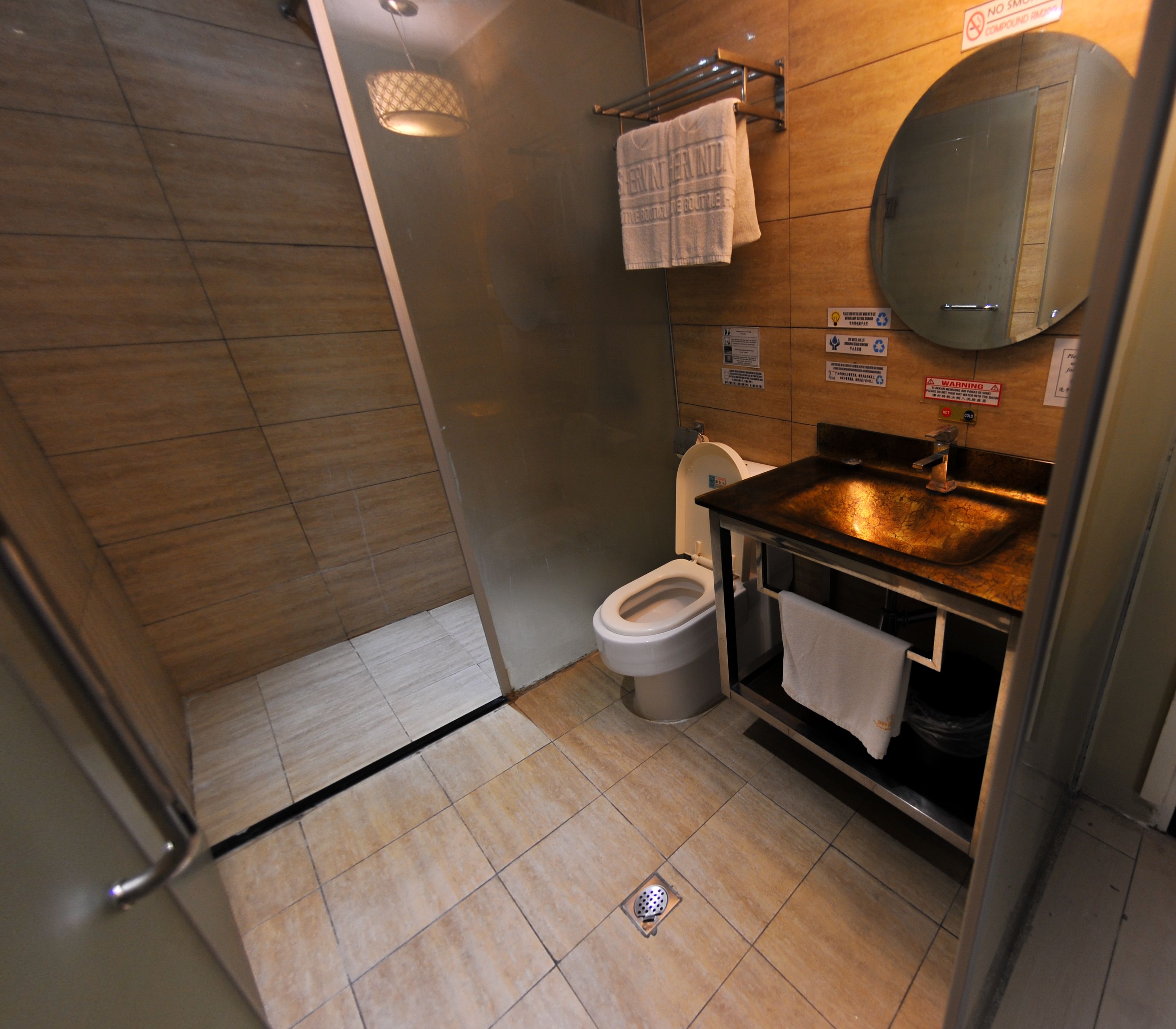 A modern bathroom with a shower, toilet, and sink.