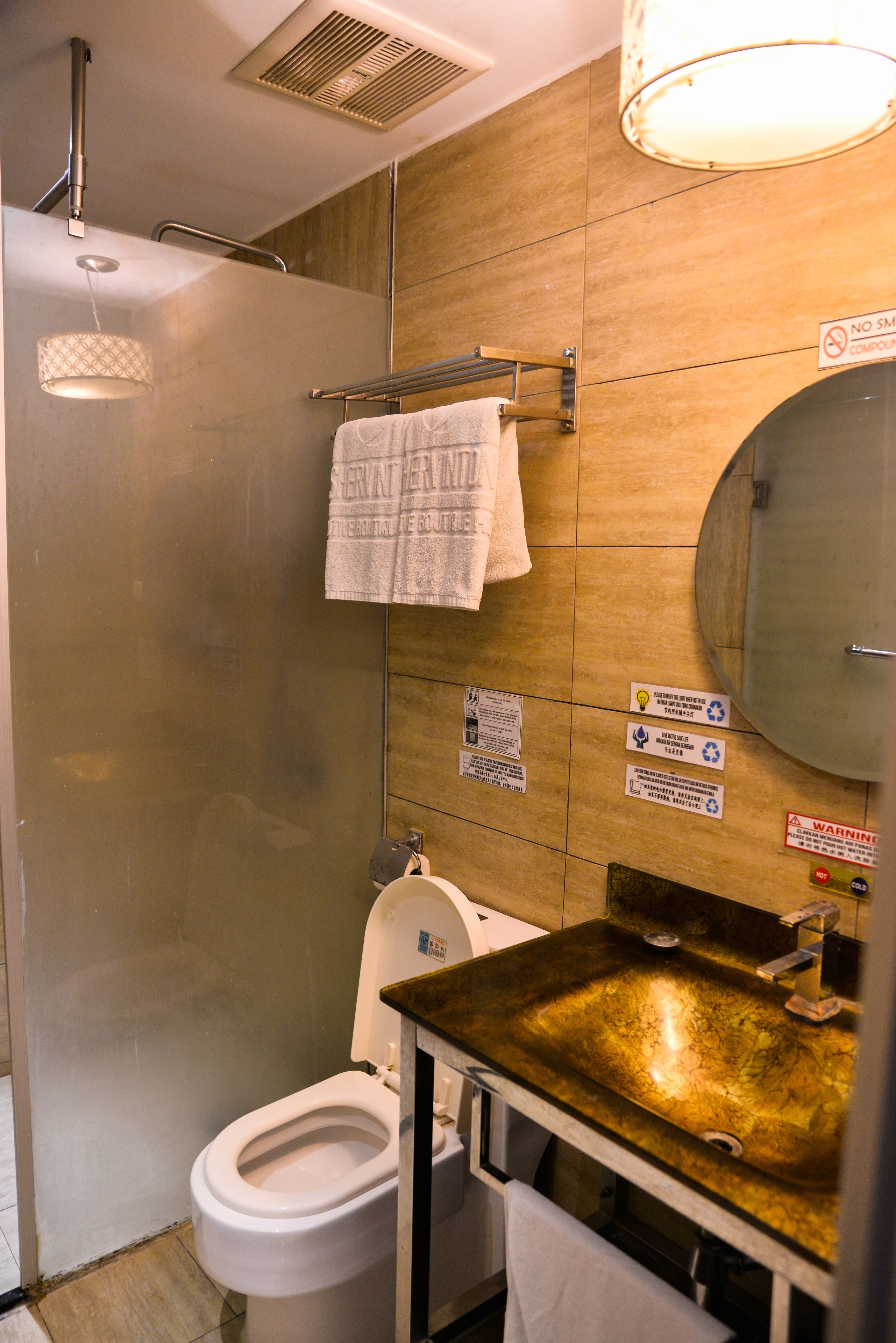A bathroom with a shower, toilet, and sink.