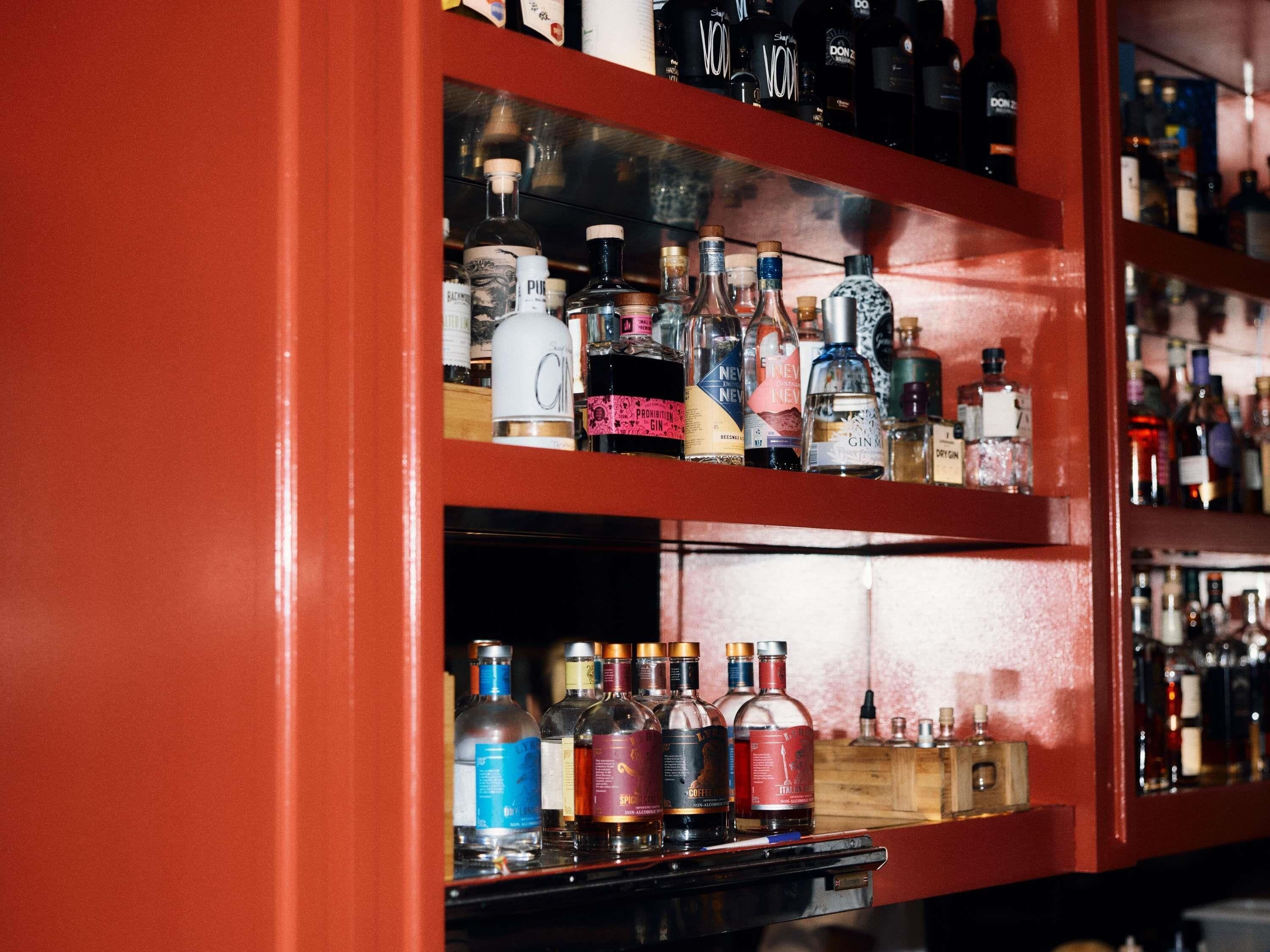 A bar with shelves of various liquor bottles.