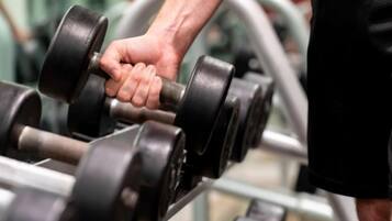 A close-up of a hand gripping a dumbbell.