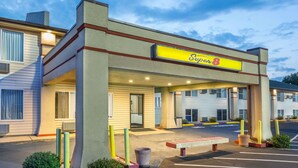 A motel with a 'Super 8' sign, a covered entrance, and a parking lot.