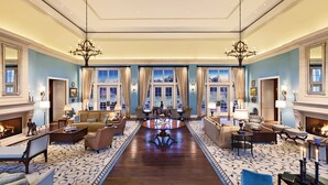 A spacious lobby with a central coffee table, seating arrangements, and a fireplace. - Salamander Resort And Spa (Middleburg)