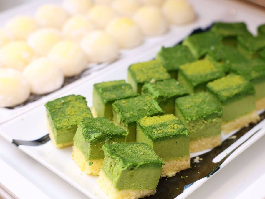 A dessert tray with green and white sweets.