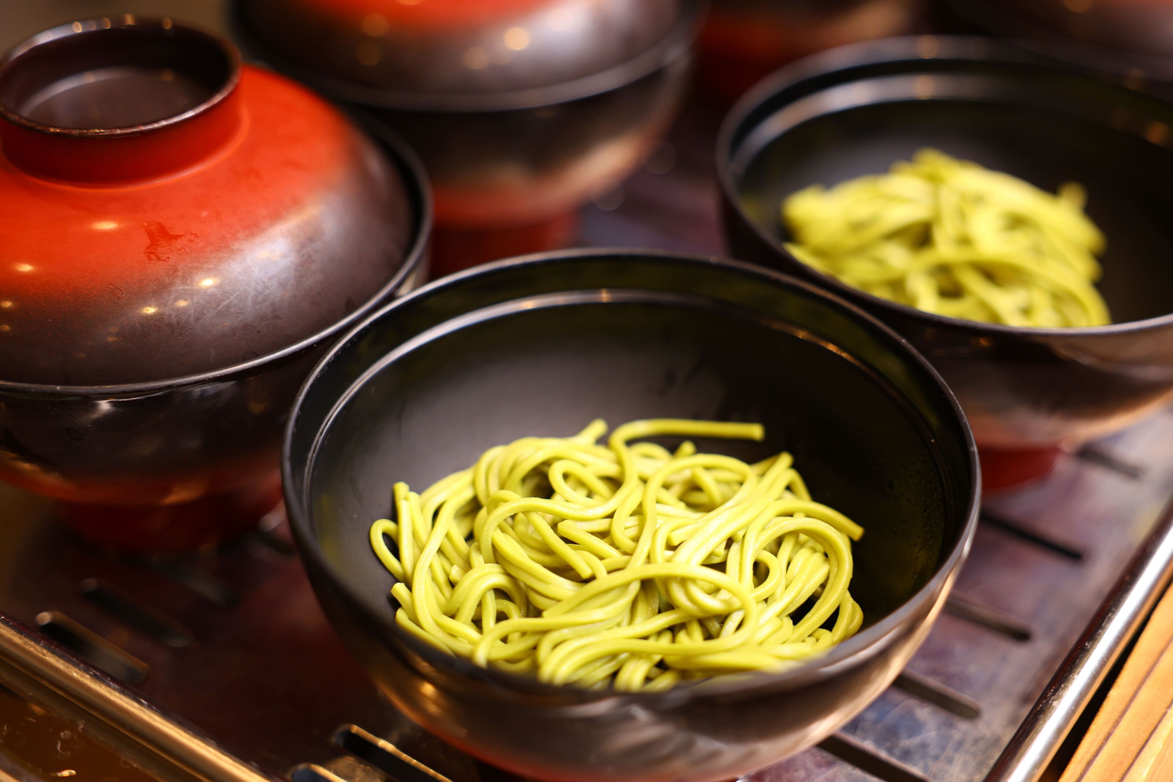 Bowls of noodles on a stove.