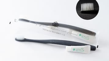 A toothbrush and a tube of toothpaste with text in multiple languages.